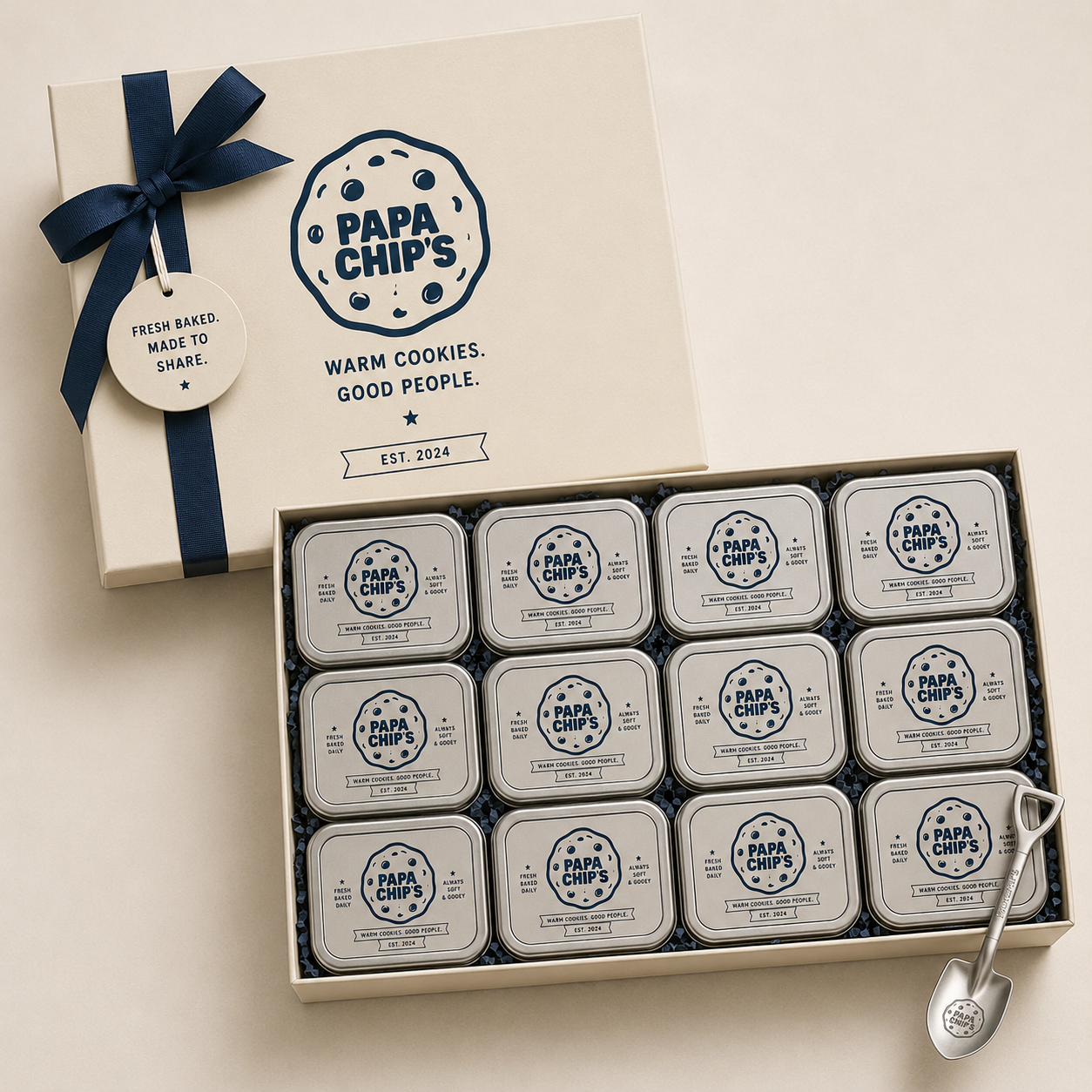 Our Signature Gift Set — 12 mini tins in a premium cream gift box with navy ribbon